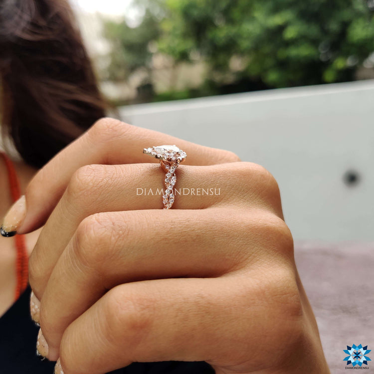 Pear shaped moissanite ring with halo and prong setting.
