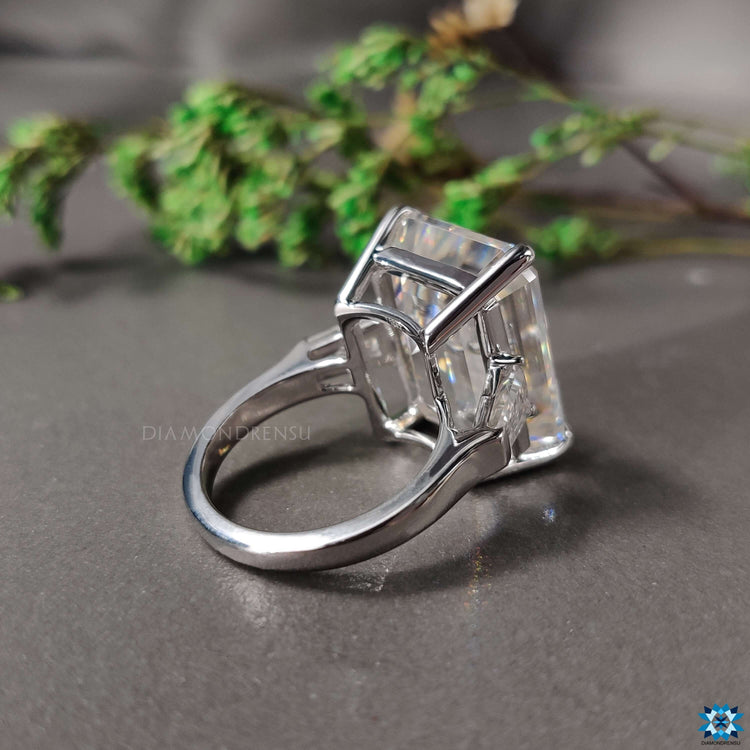 Custom engagement ring with emerald and baguette cuts.
