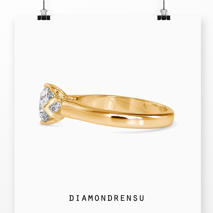 Rose gold engagement ring with round diamond and tulip design.
