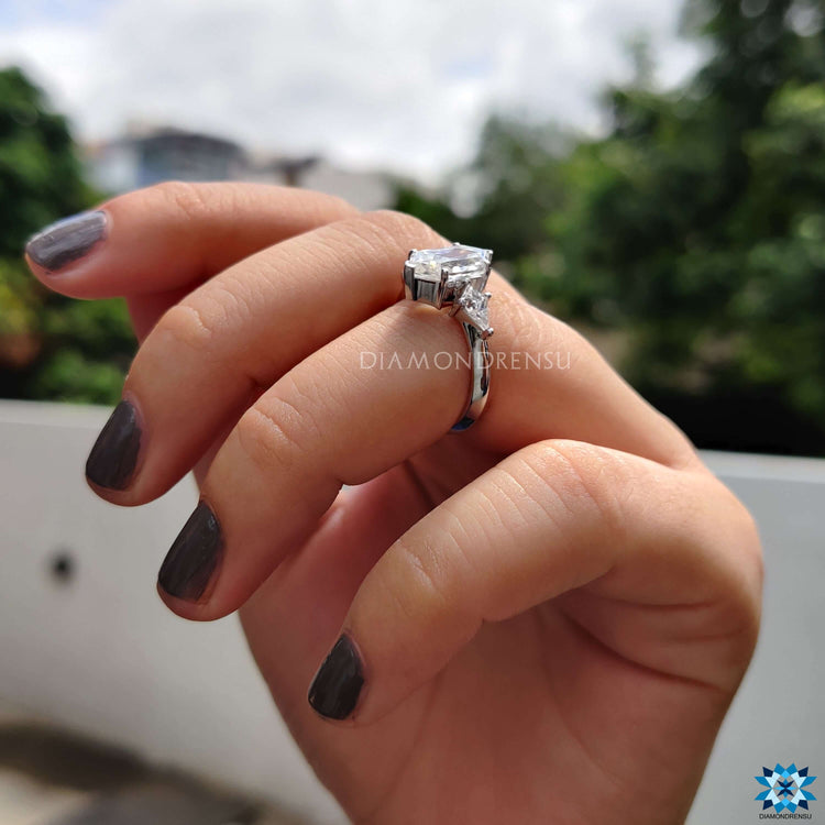 Elongated hexagon moissanite engagement ring crafted in white gold by Diamondrensu UK.
