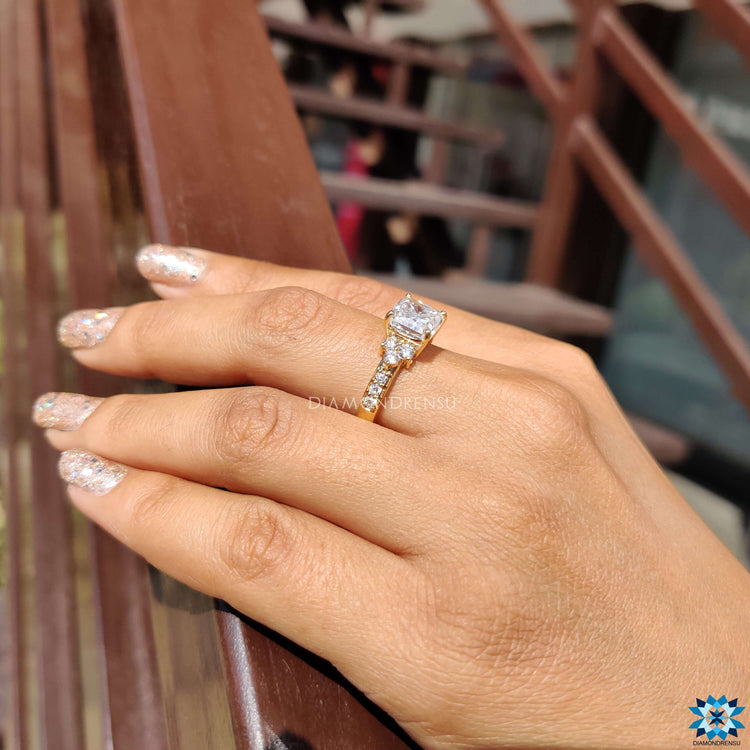 Radiant moissanite center stone with round side stones.
