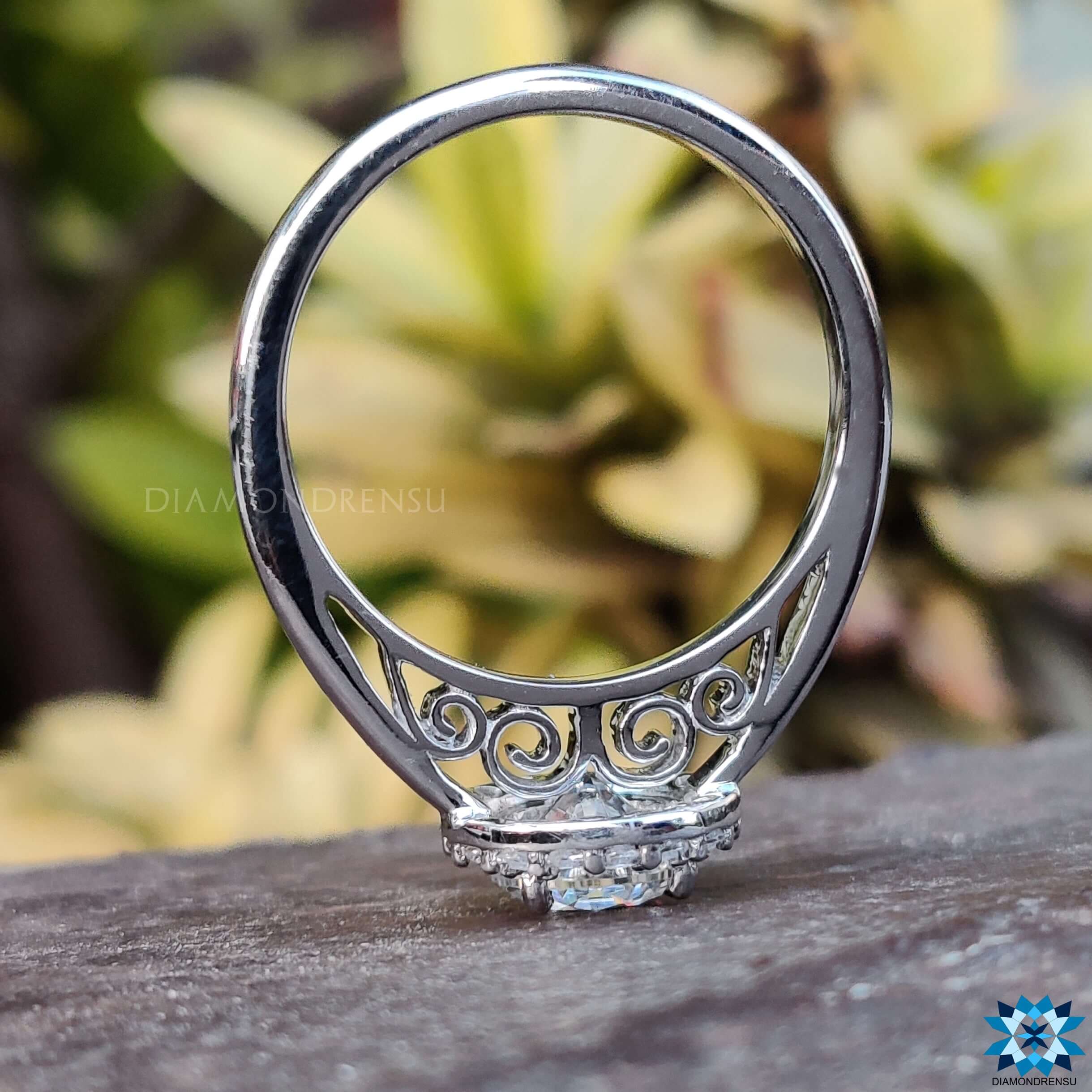 Filigree ring with intricate details and a sparkling halo ring setting.