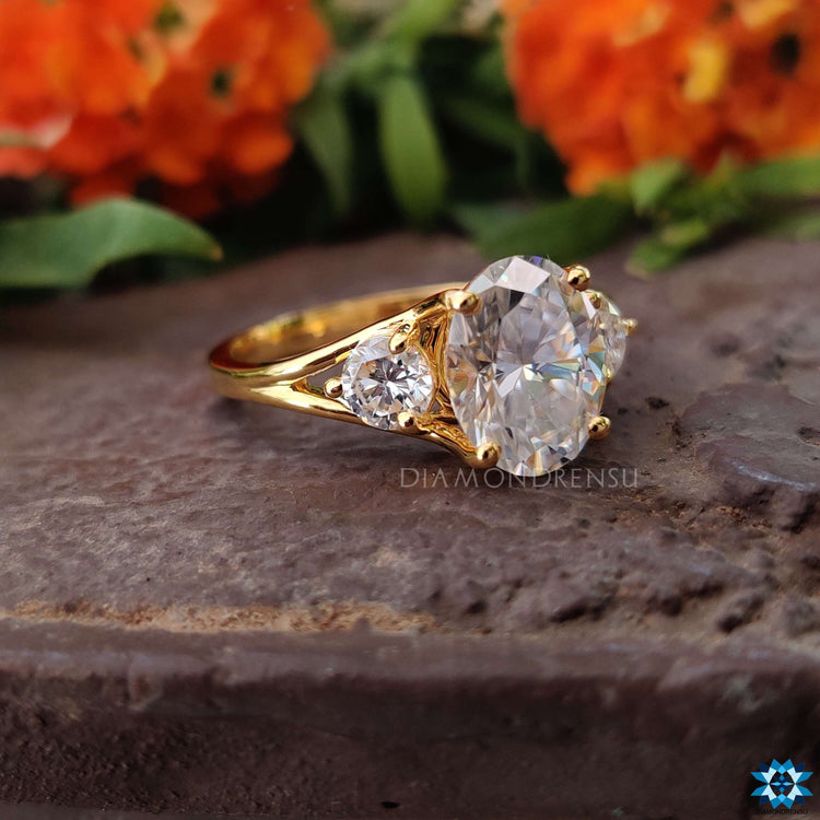Handmade three stone ring in yellow gold with prong setting.
