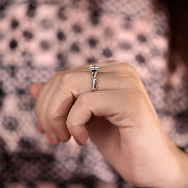 White gold engagement ring with a pave diamond band.
