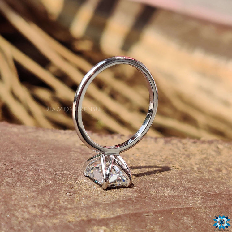 Solitaire setting ring crafted in white gold with radiant moissanite.
