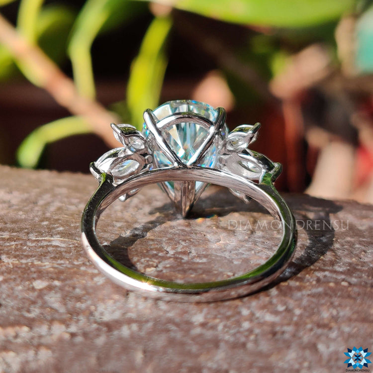 Custom moissanite engagement ring with side stones.
