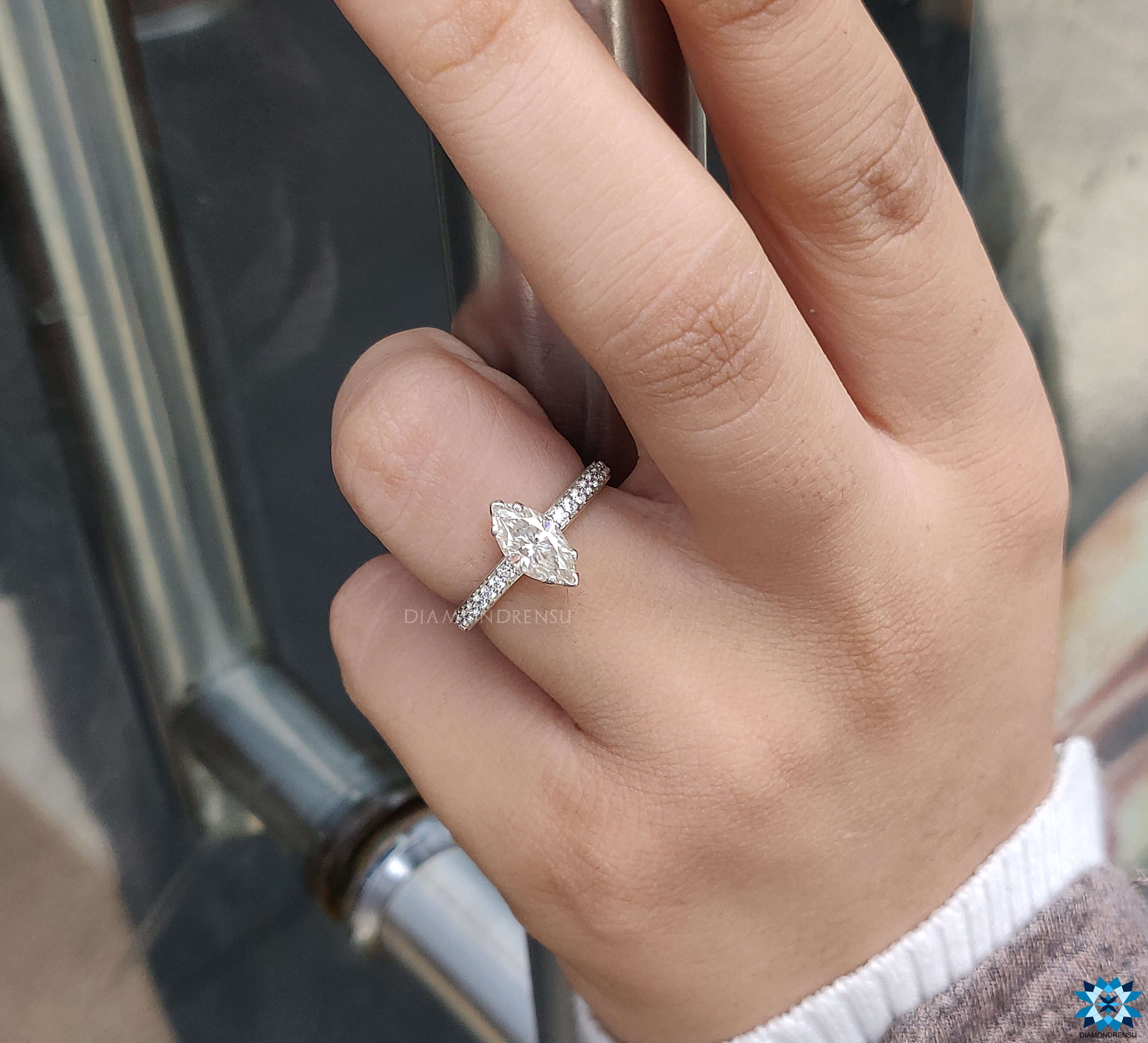 Moissanite for engagement ring with marquise cut and pave setting for brilliance.