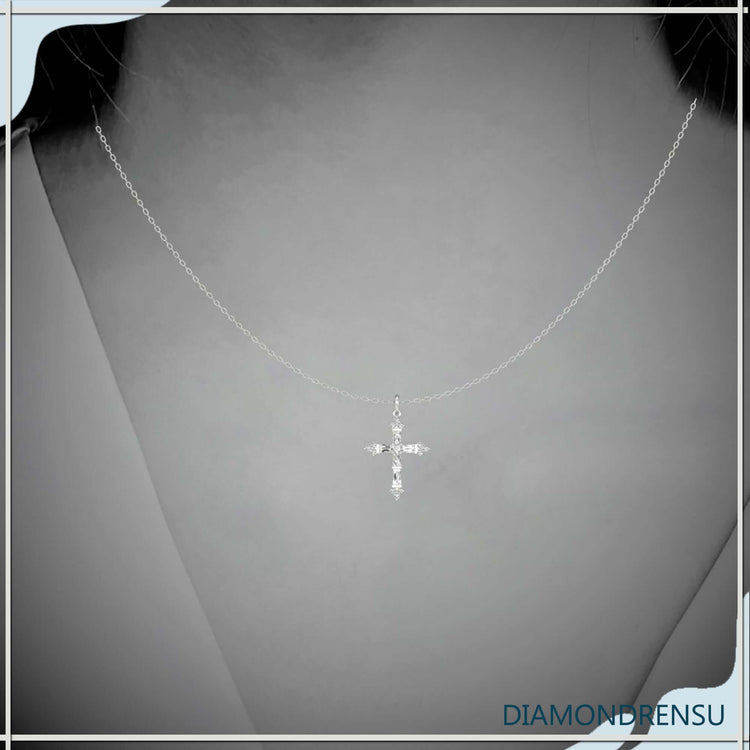 White gold round cross pendant with tapered baguette diamonds.
