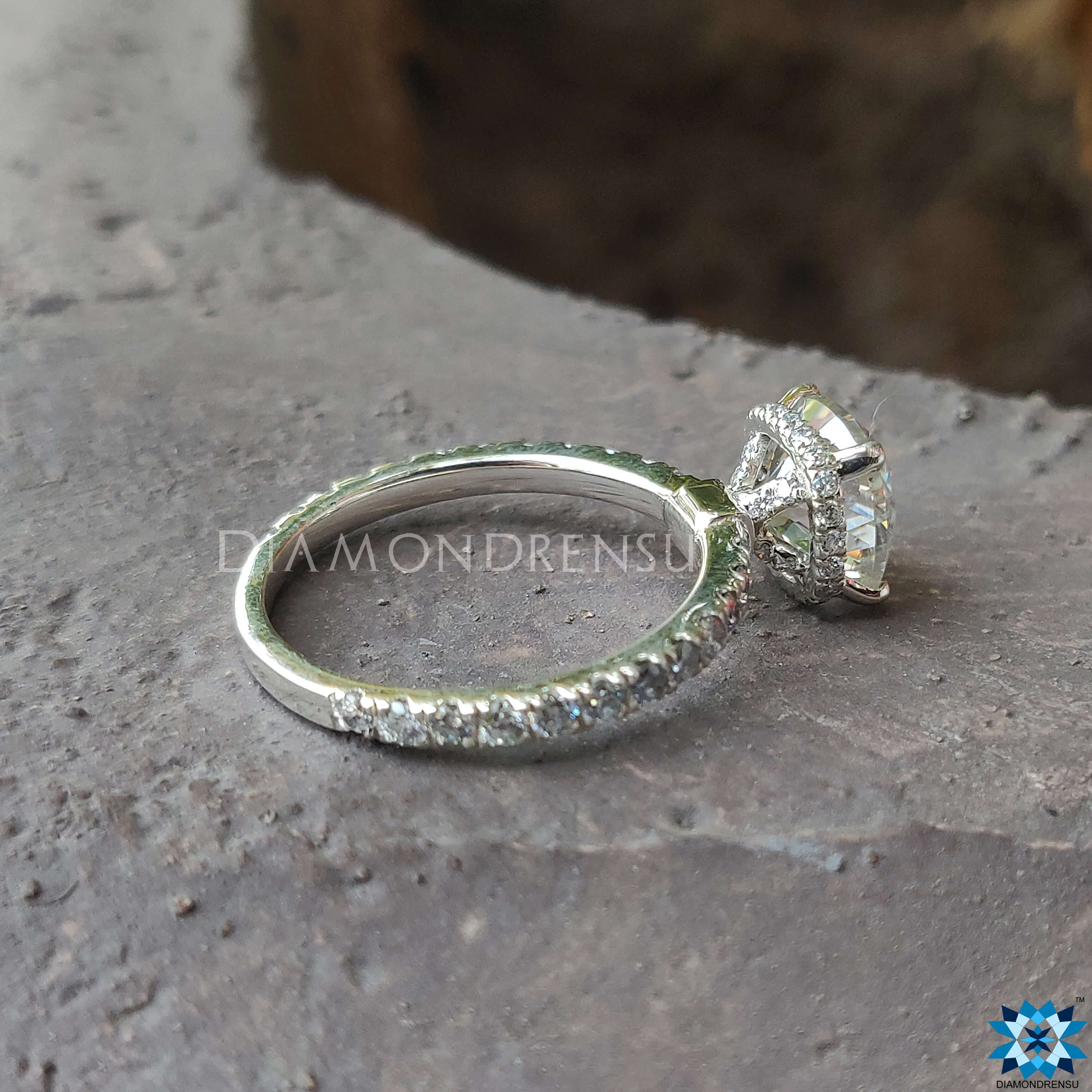 White gold engagement ring with a cushion cut moissanite centre stone.