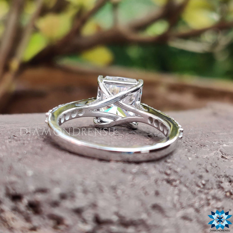 4 prong setting ring with radiant cut moissanite and round pave accents.
