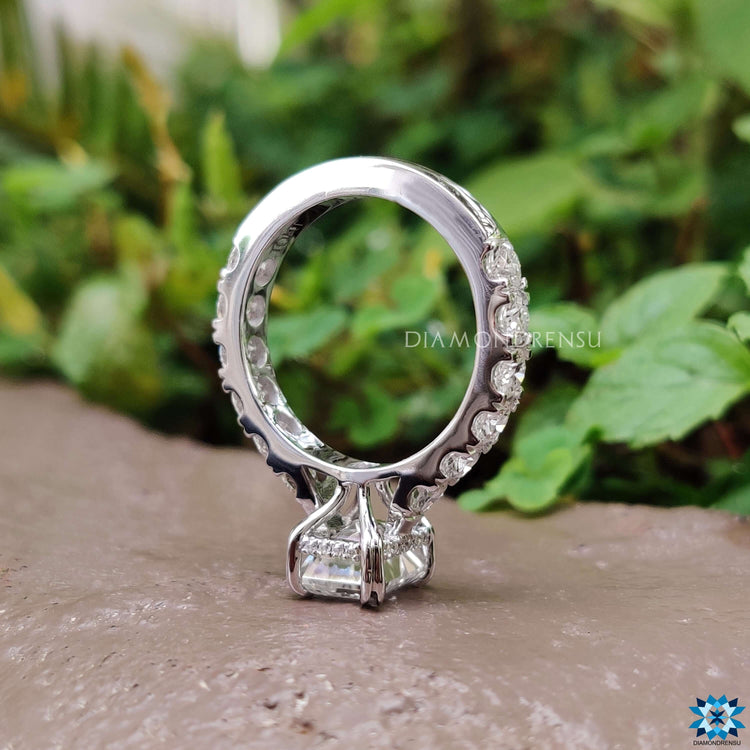 Custom engagement ring featuring emerald cut moissanite.
