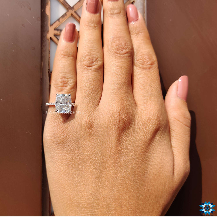 Elongated cushion cut ring with rose gold halo.

