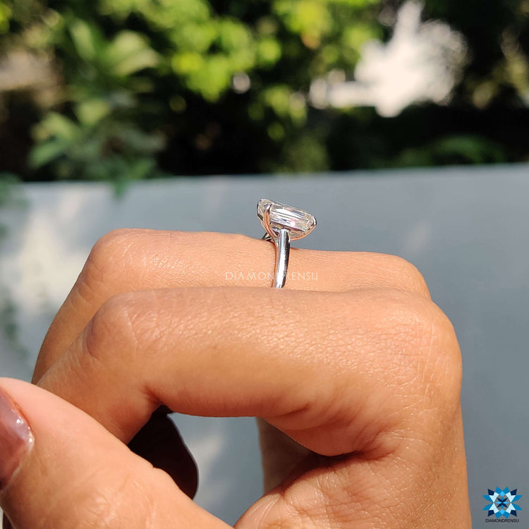Cathedral setting solitaire ring with criss cut moissanite center.
