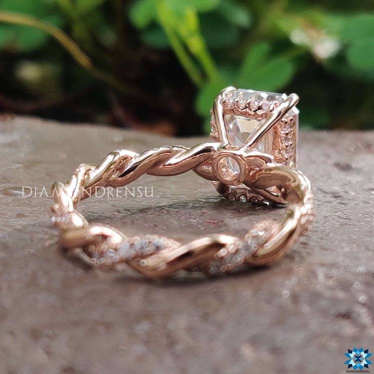 Twisted shank engagement ring with emerald cut center.
