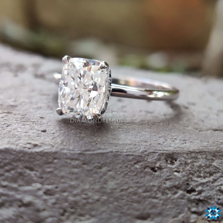 White gold ring with elongated cushion moissanite center.
