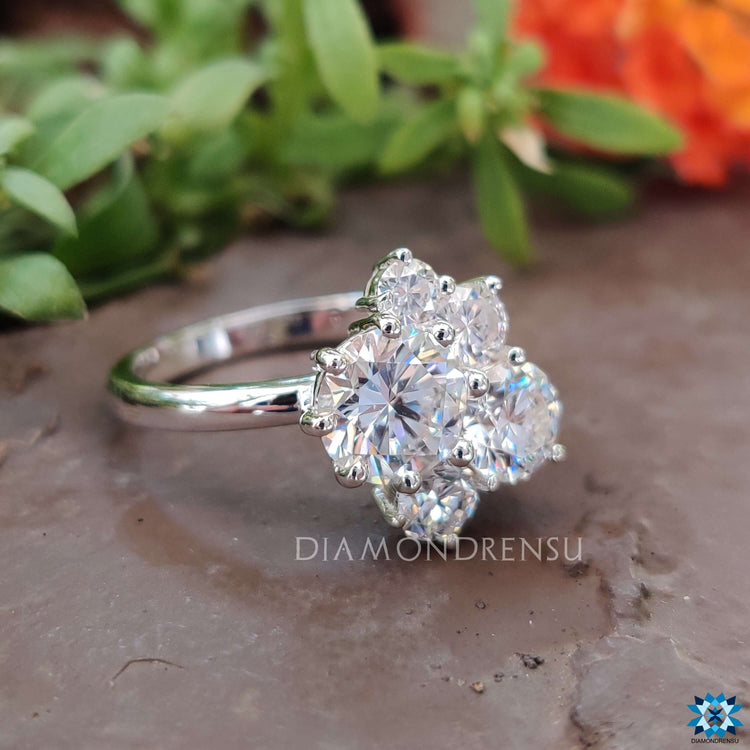 Prong setting ring showcasing five brilliant moissanite stones.
