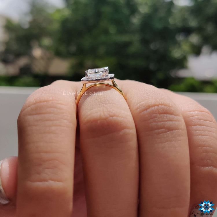 Radiant cut moissanite halo ring with milgrain accents.
