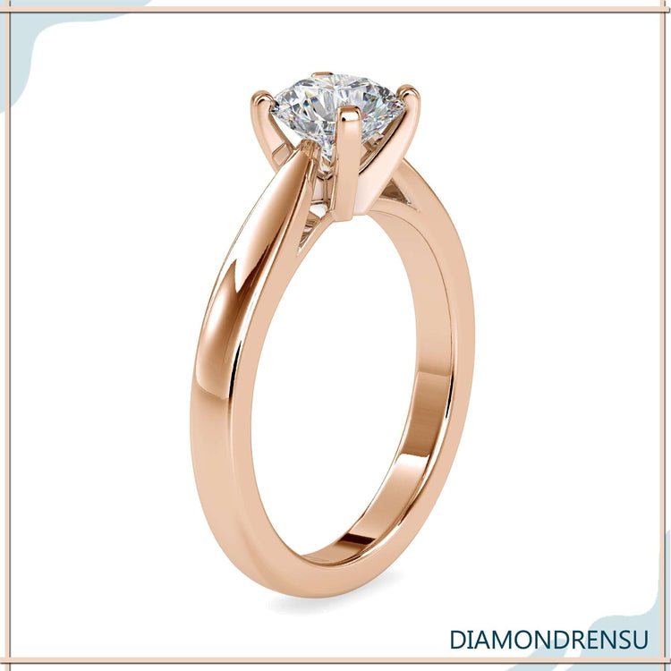 Rose gold engagement ring with round diamond centre.
