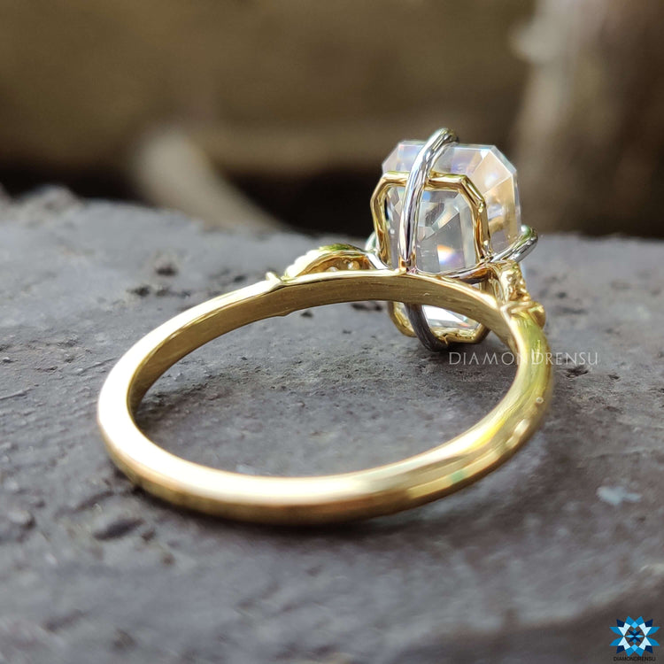 Handmade yellow gold ring featuring emerald cut center.
