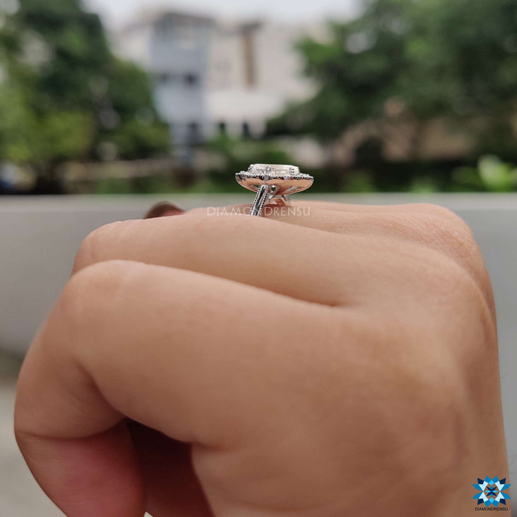 Custom engagement ring with halo cluster and milgrain touches.
