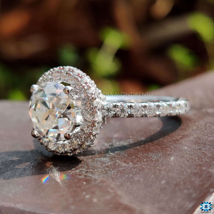 Round cut old European moissanite ring with pave band.
