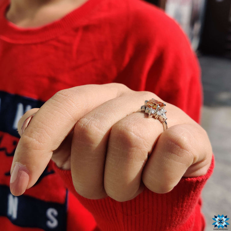 White gold cushion moissanite ring with handcrafted muse-inspired setting.
