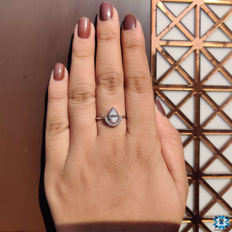 White gold moissanite ring with vintage style and intricate details.