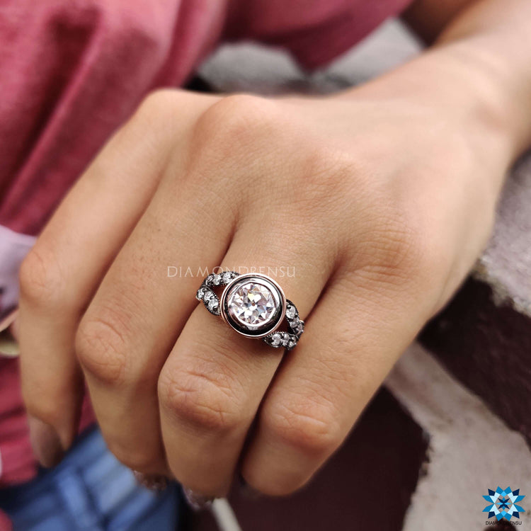 Rose gold moissanite engagement ring with vintage design.
