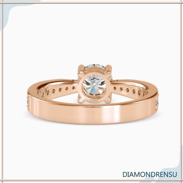 Custom engagement ring with tapered shank and round diamond.
