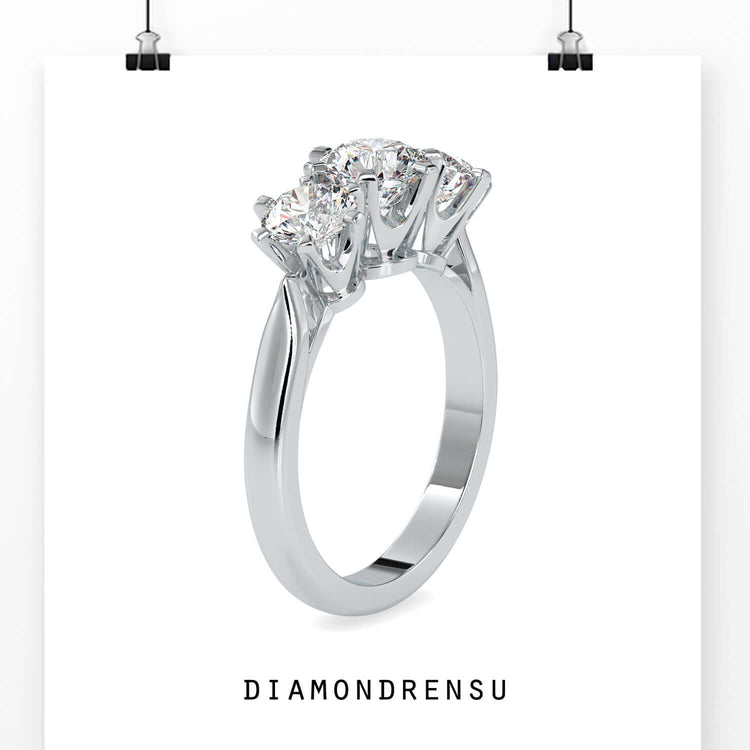 Handmade ring featuring three round diamonds and six prong mount.
