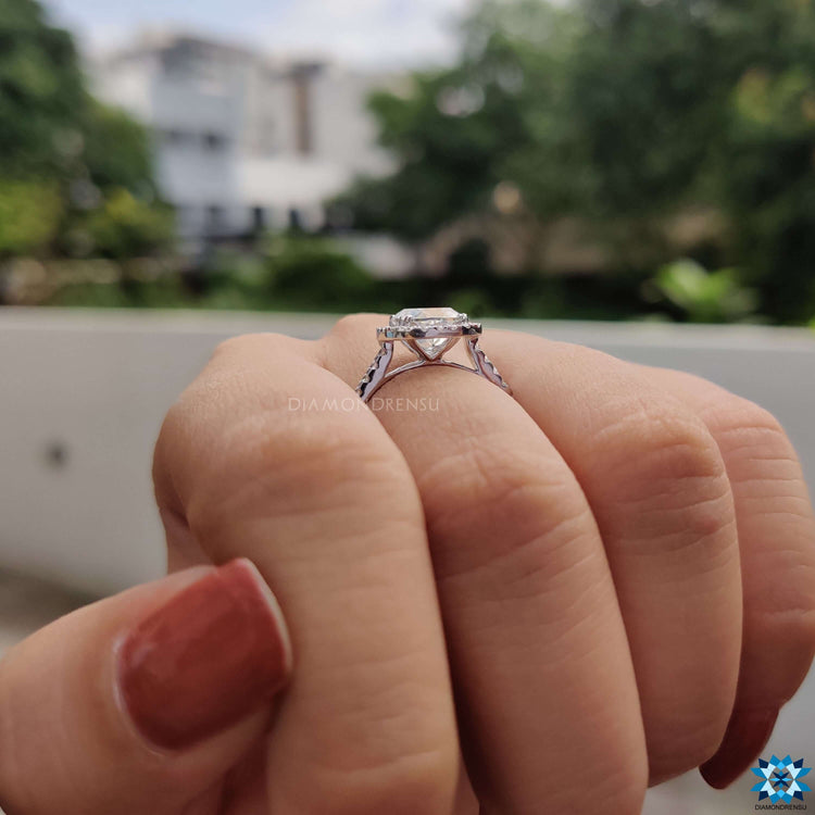 Double prong setting ring featuring cushion cut moissanite in halo style.

