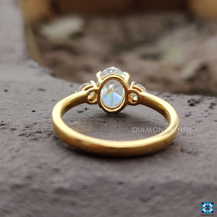 Yellow gold ring with oval rose cut center and round sides.
