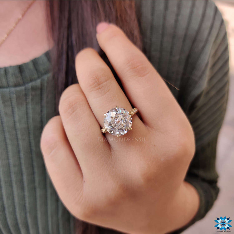 Round cut pave band on yellow gold moissanite ring.
