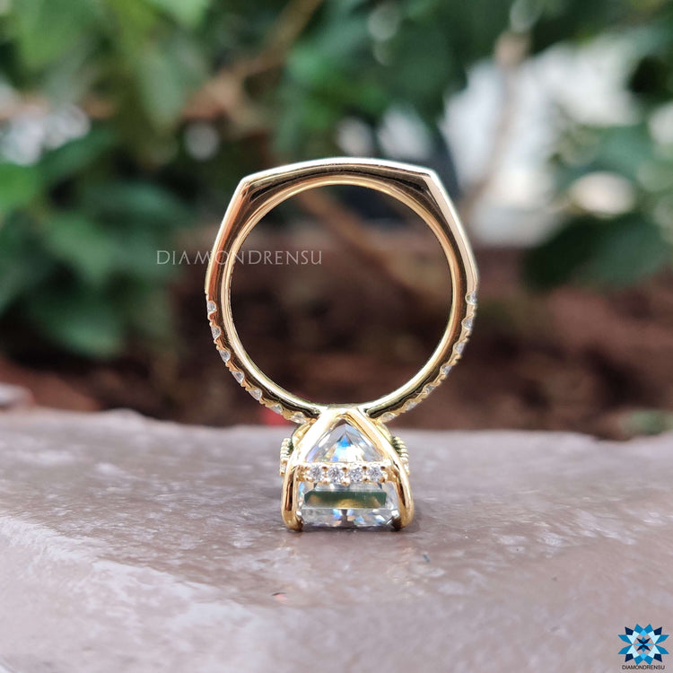 Radiant cut moissanite ring with 4 claw prong mount.
