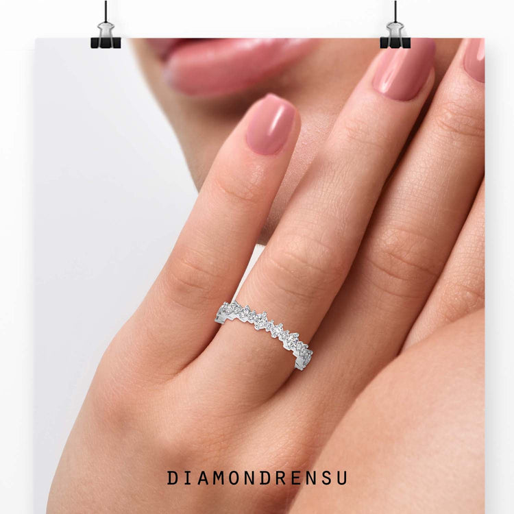 Round diamond wedding band crafted in white gold.
