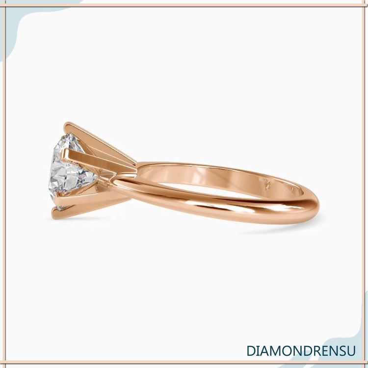 Custom engagement ring in gold with round solitaire design.
