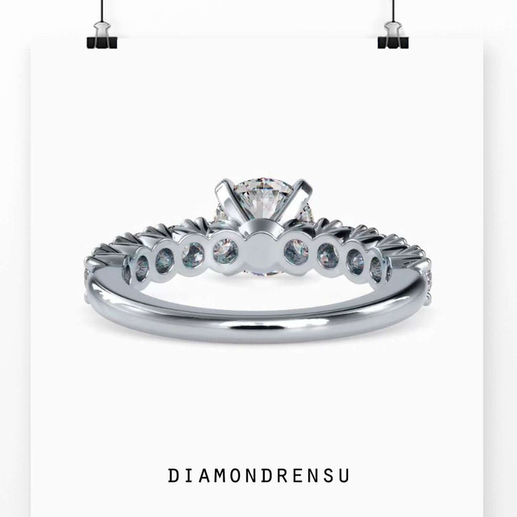 Diamondrensu UK engagement ring with round cut pave diamonds.

