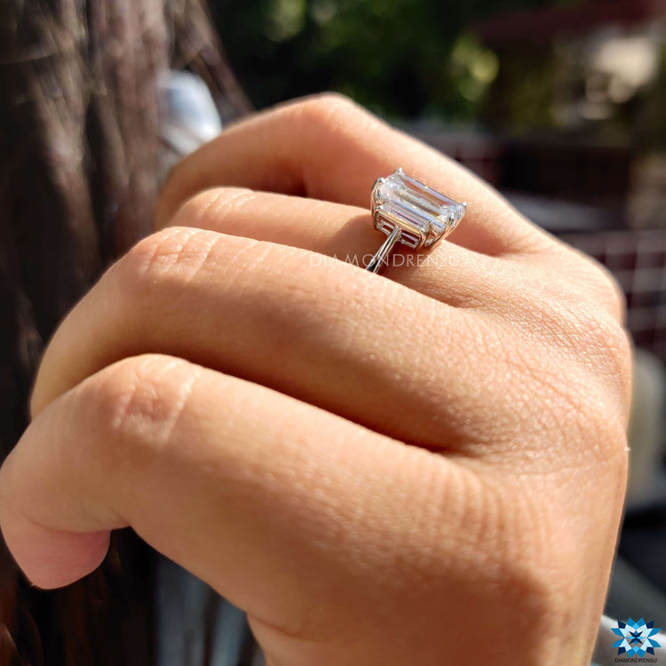 Elongated cushion stone held securely in a prong setting.
