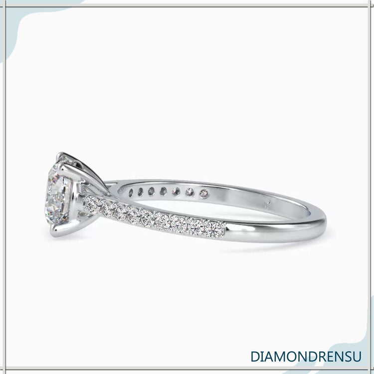 Rose gold engagement ring with round diamond and pave band.
