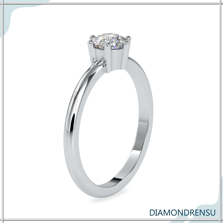 Custom design engagement ring with round diamond in six prong setting.
