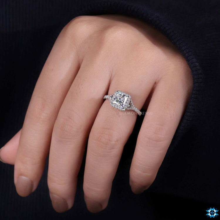 Round cut pave halo moissanite ring.