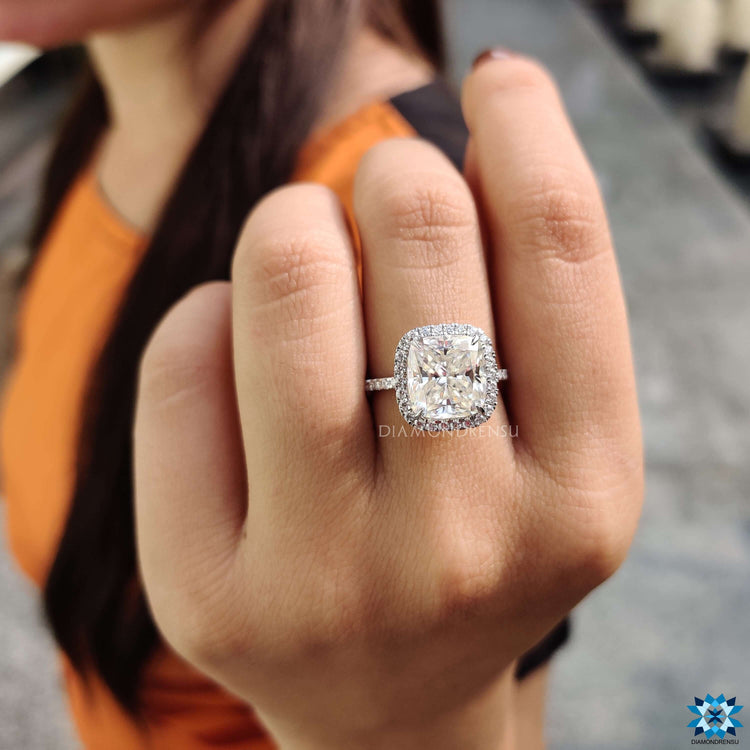 Moissanite halo ring with round cut accents.
