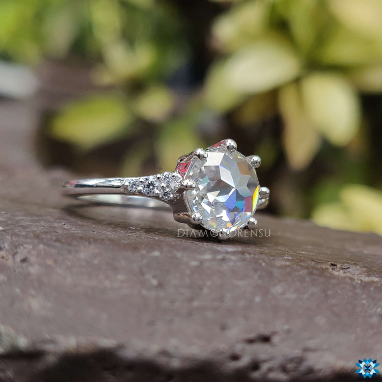 Prong setting ring featuring round rose cut Moissanite and custom detailing.
