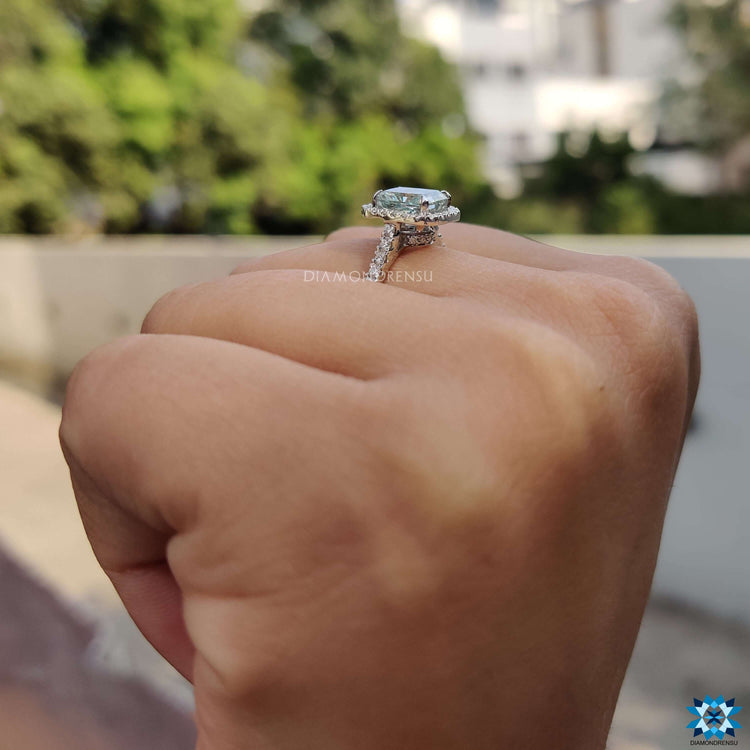 Radiant moissanite engagement ring crafted with hidden halo and claw prongs.
