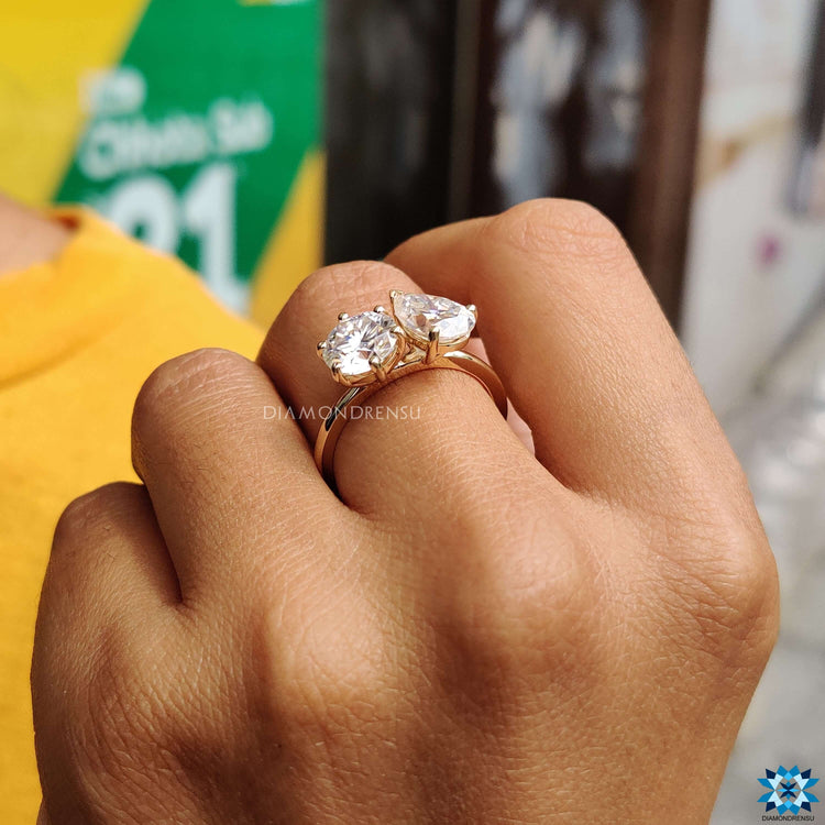 Yellow gold engagement ring with dual moissanite stones.
