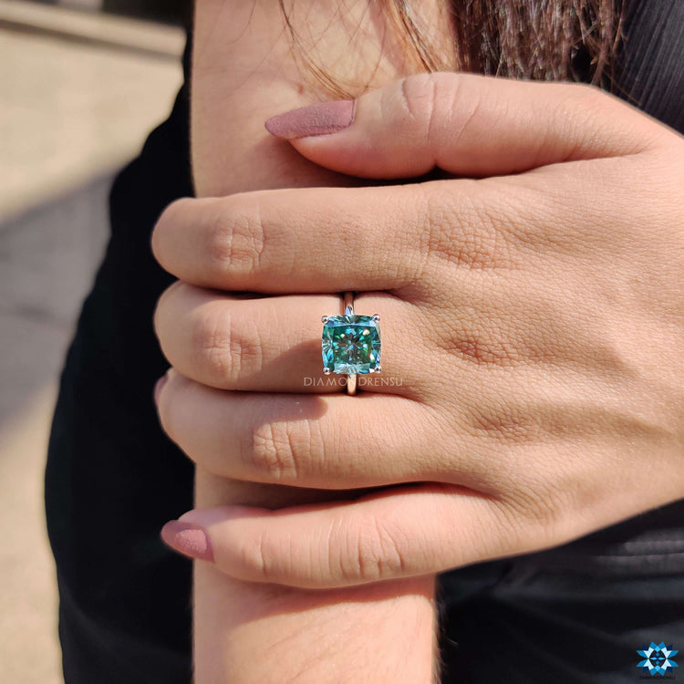 Cyan blue moissanite in solitaire setting ring.
