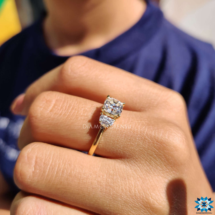 Three stone moissanite ring with claw prong setting.
