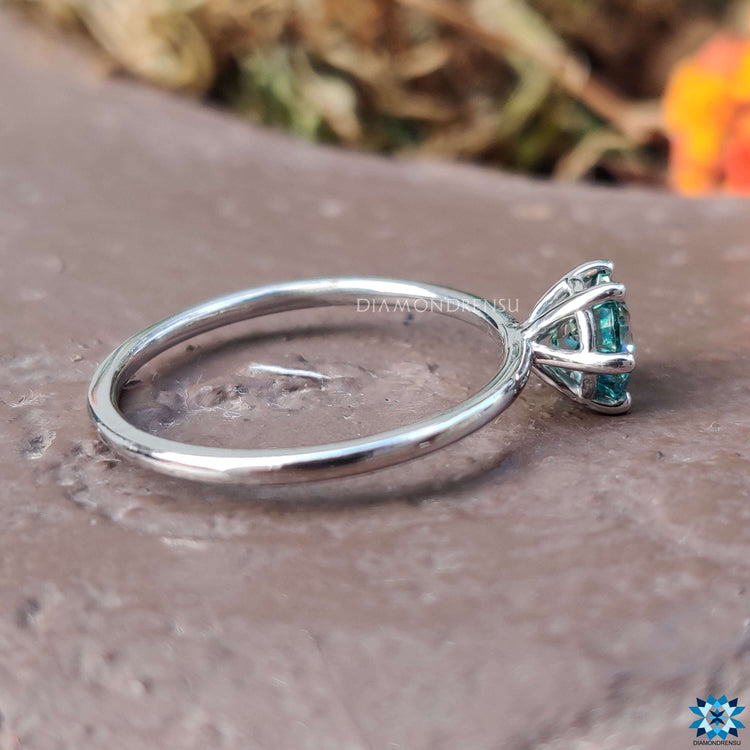 Handmade solitaire ring with blue moissanite center.
