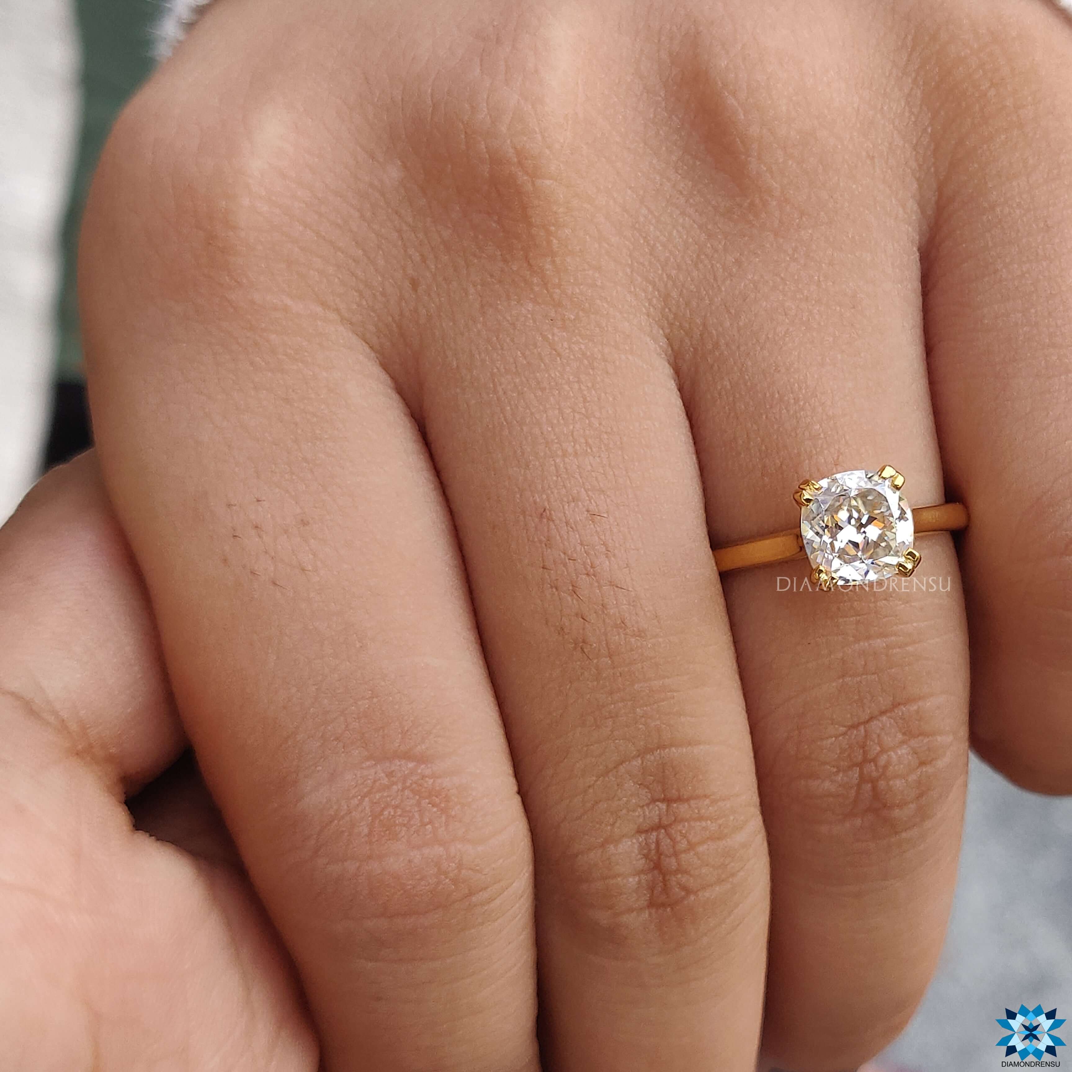 A stunning Cushion Cut Moissanite Solitaire Ring that highlights the beauty of the center stone.
