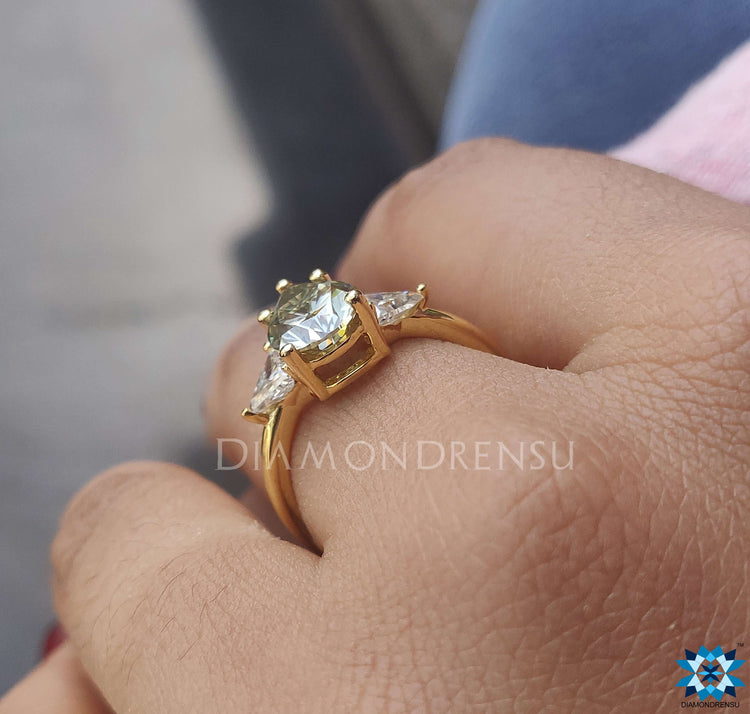 Handmade ring with a unique pear shaped and triangle moissanite design.